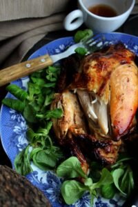 Close-up of a whole roasted chicken ready for storage