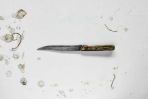 A worn kitchen knife with a wooden handle, how to dispose of kitchen knives safely