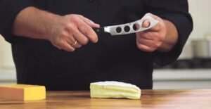 why do some cheese knives have holes