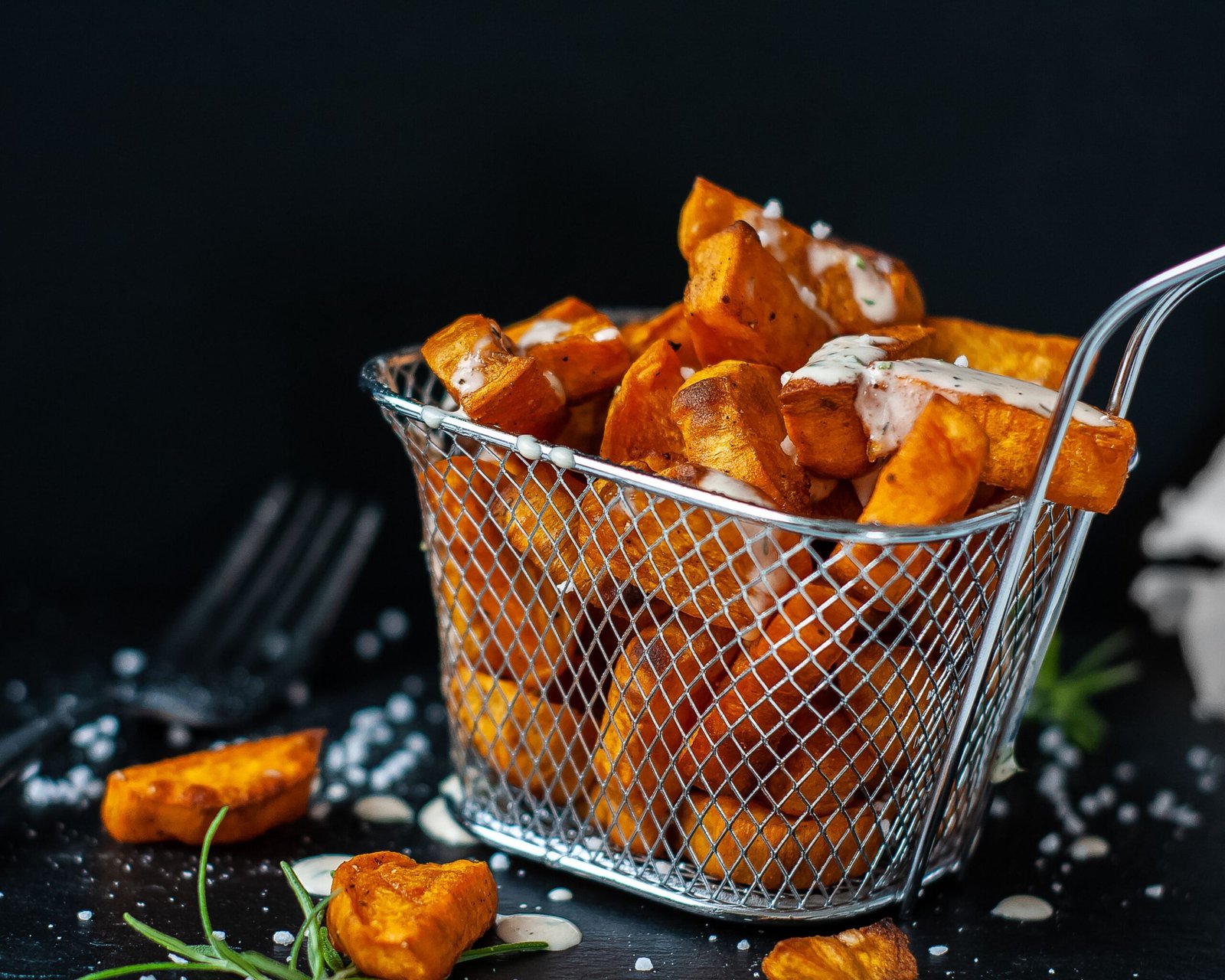 Crispy sweet potato fries in a basket, ready after air frying