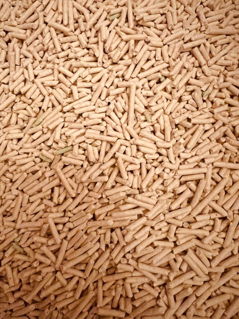 Pile of food-grade hardwood wood pellets used for smoking on a gas grill