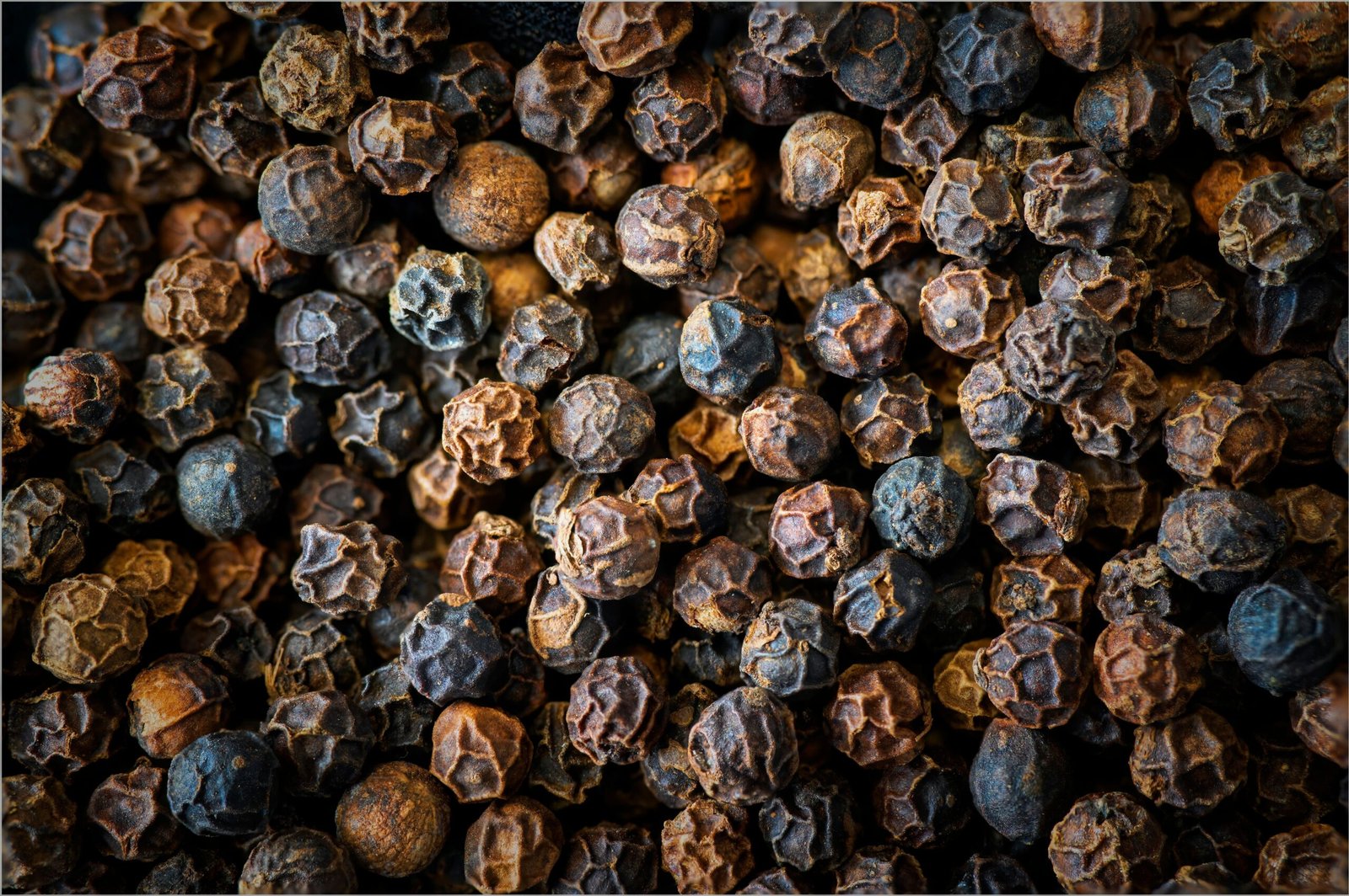 Close-up of whole black peppercorns