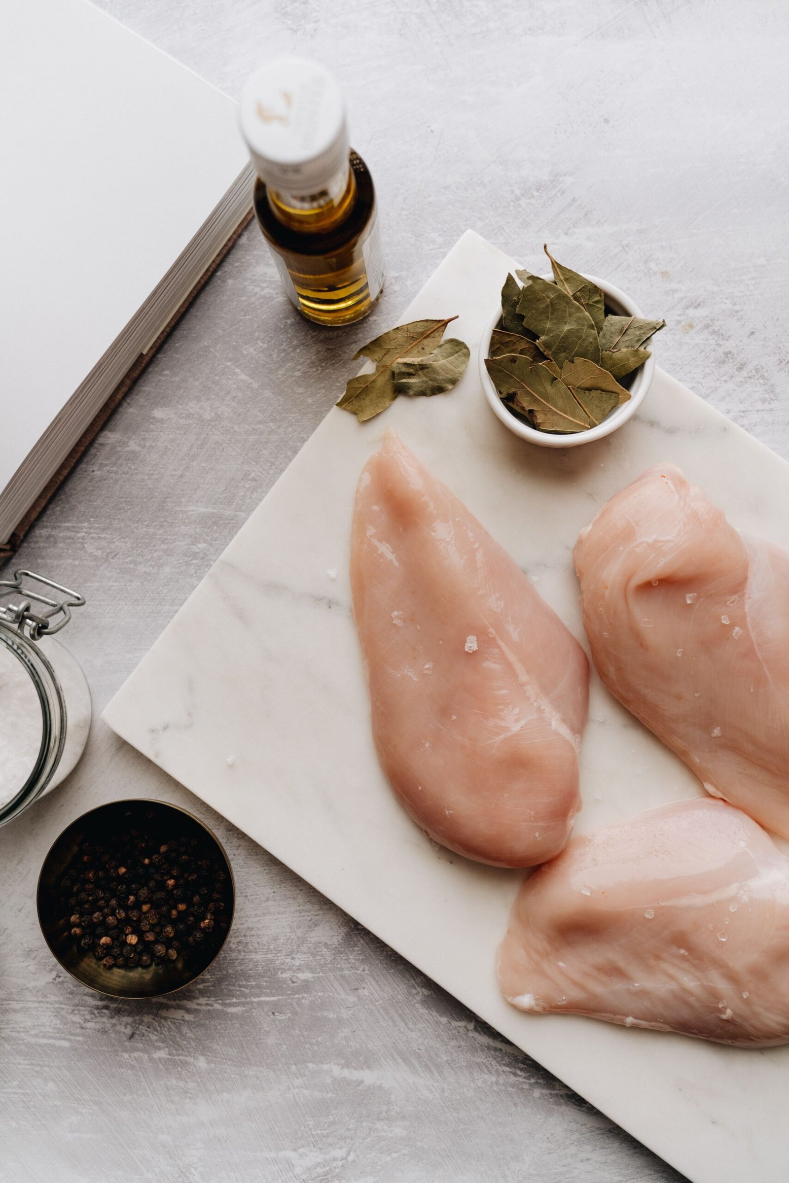 Chicken breasts being prepared on a kitchen counter before steaming