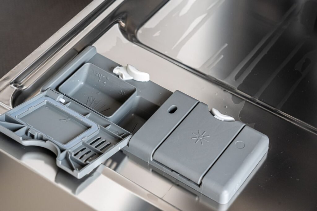 Close-up of a dishwasher detergent dispenser
