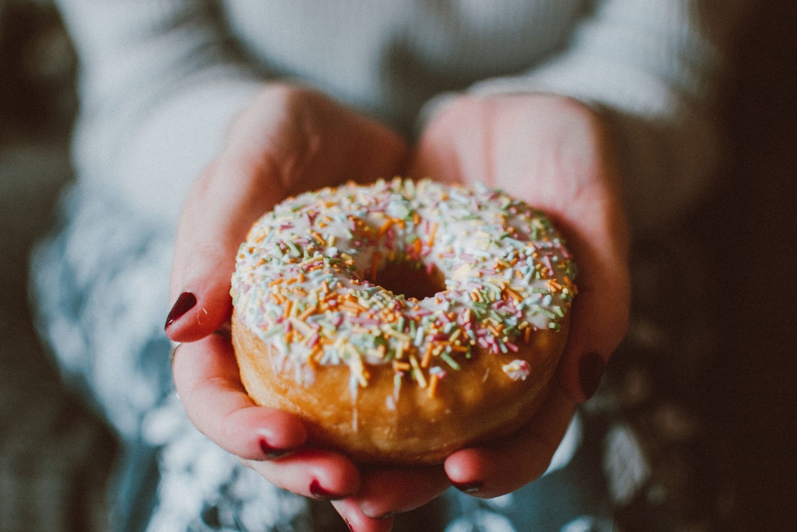 close-up of a finished doughnut with colorful sprinkles