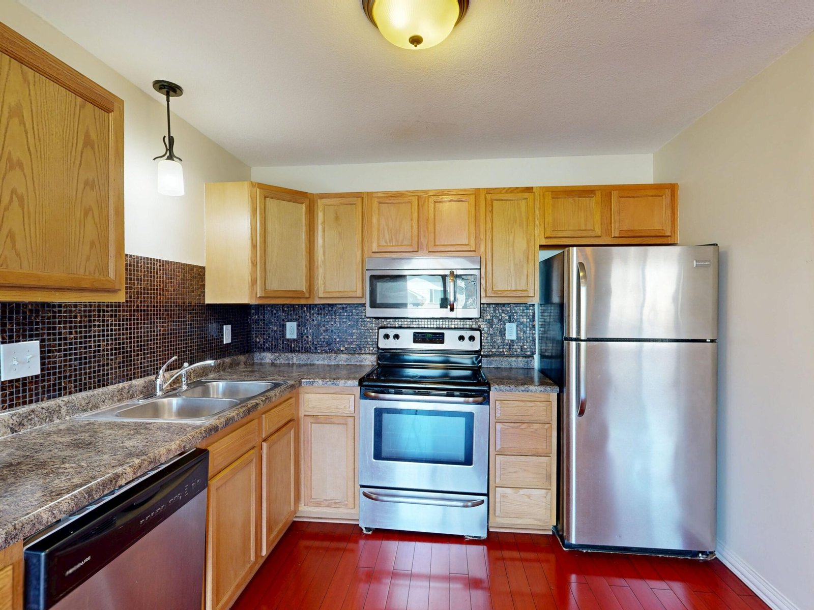 modern kitchen with stainless steel appliances including a freestanding dishwasher
