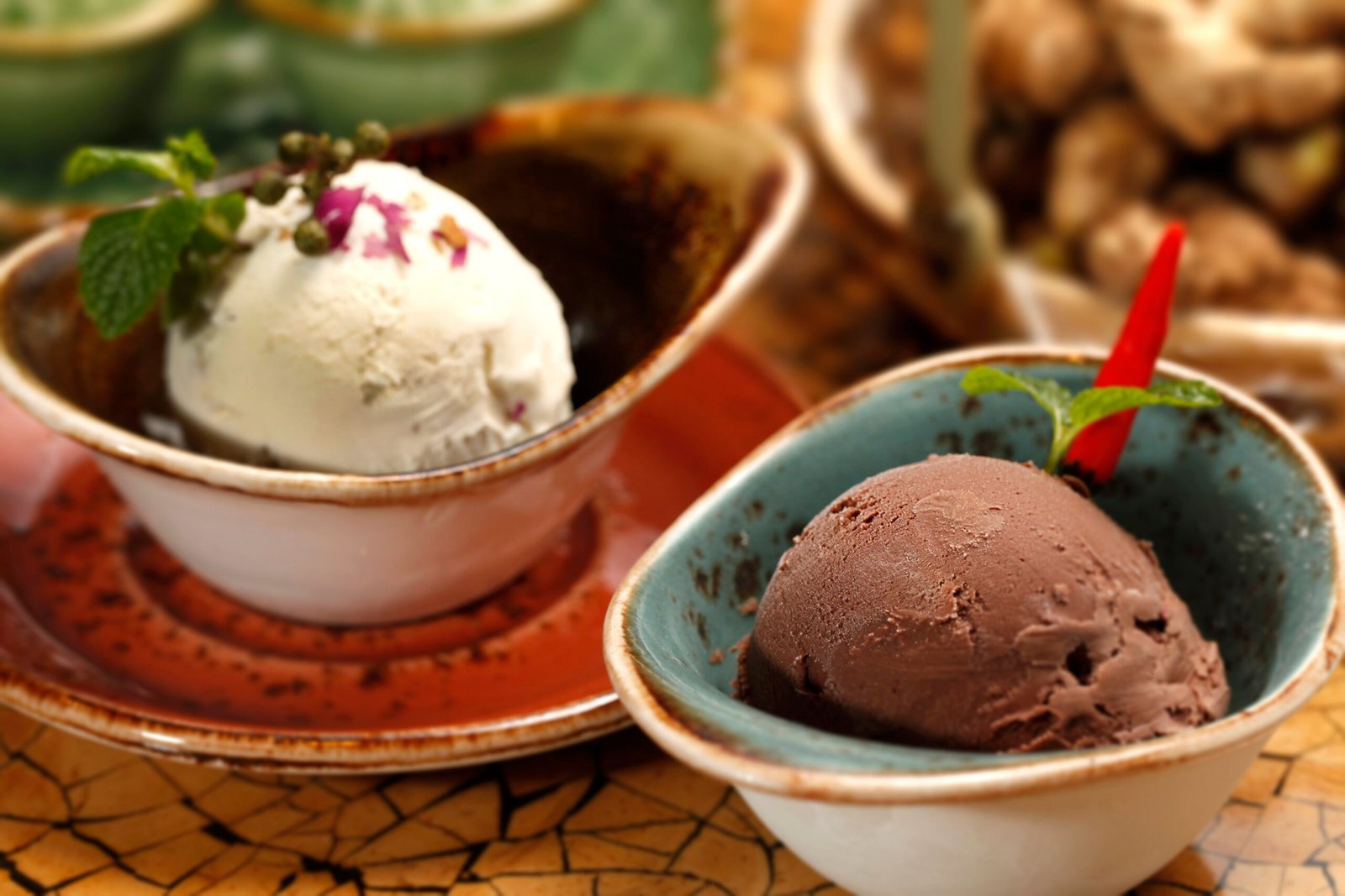 close-up of homemade chocolate and vanilla ice cream scoops served in bowls with garnishes