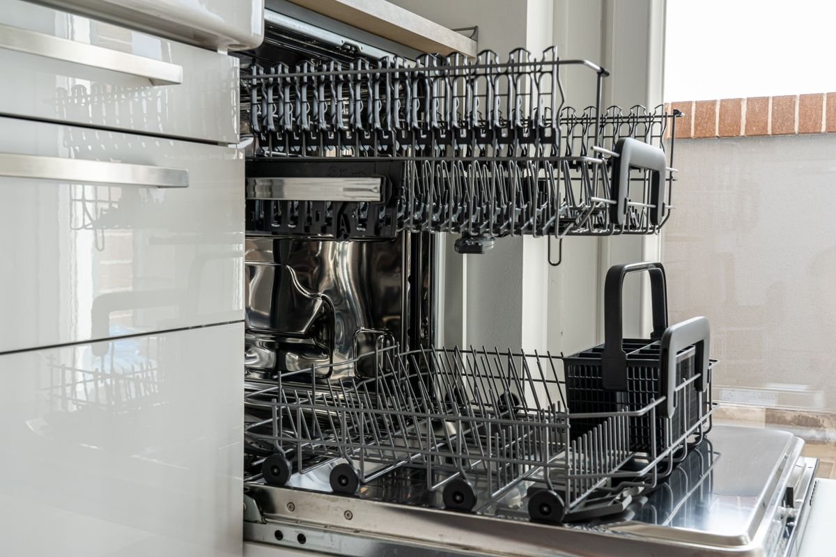 open dishwasher rack in a U.S. kitchen after the drain hose is properly connected