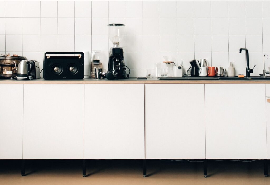 kitchen counter with a coffee maker, kettle, and small appliances
