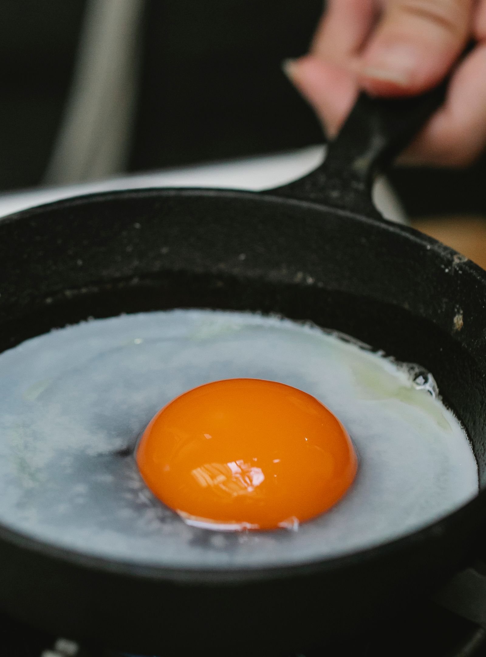 fried egg cooking in a coated nonstick pan on the stovetop