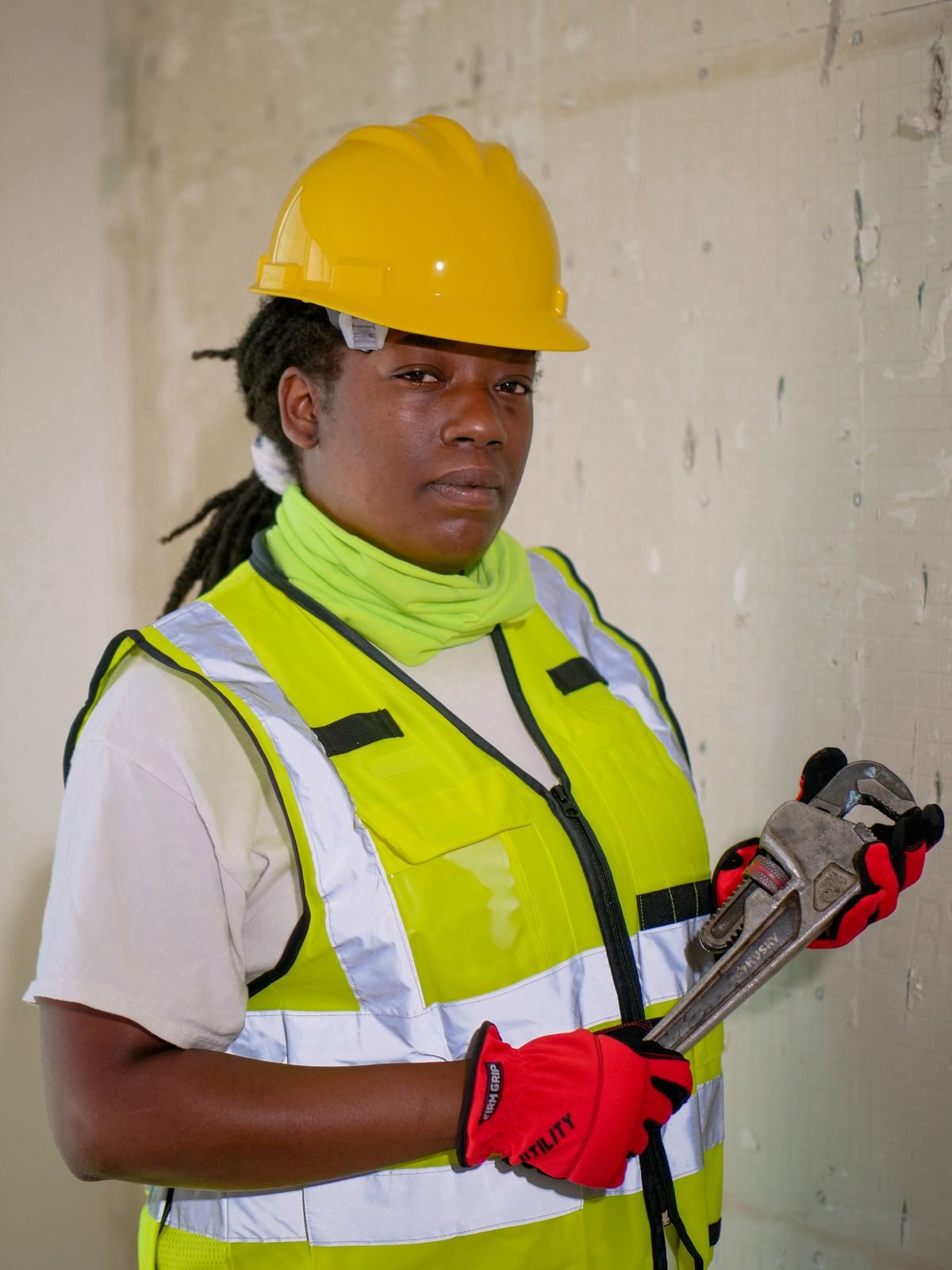 A person holding a plumber's wrench, ready for kitchen sink plumbing work