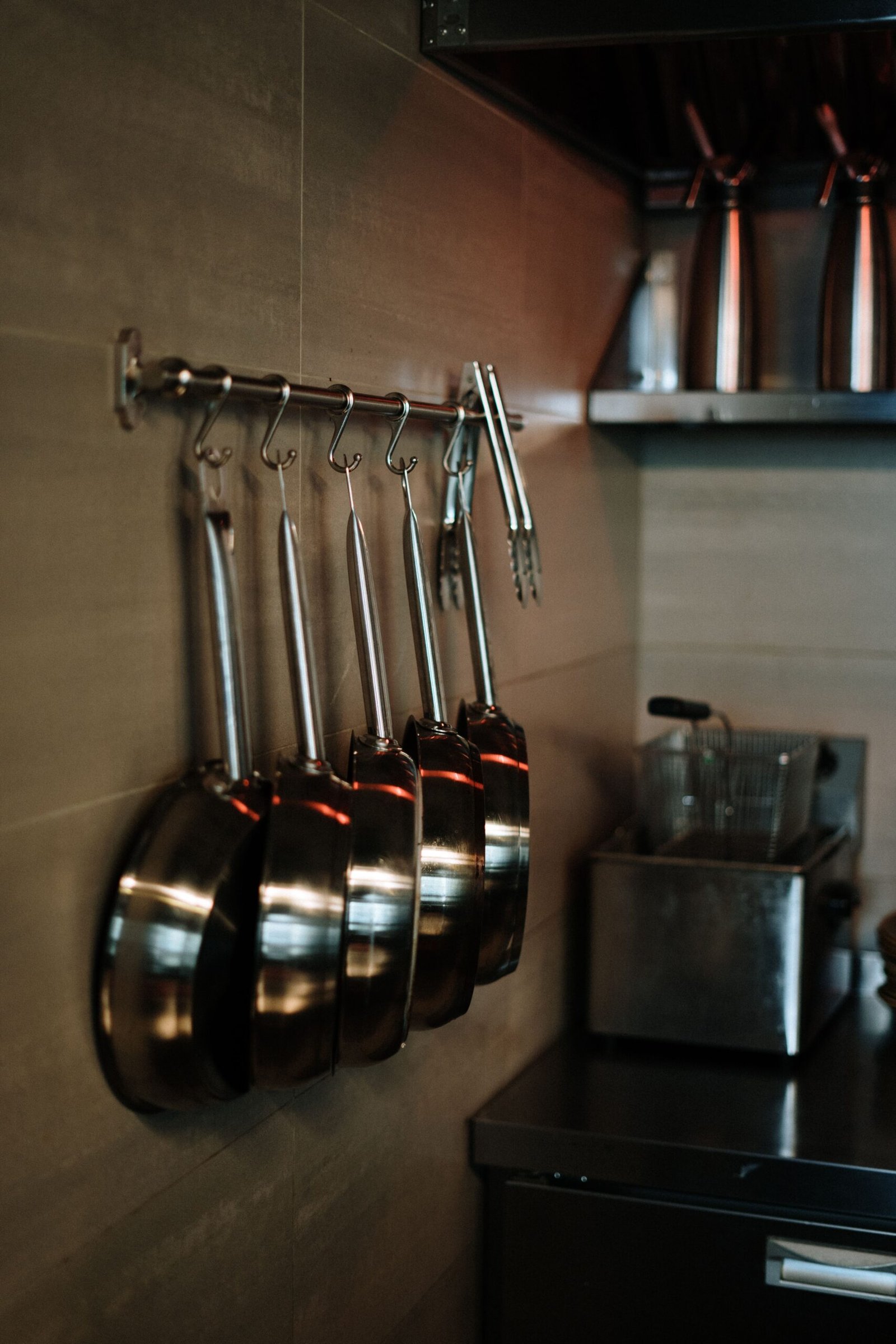 stainless steel pans hanging in a modern kitchen