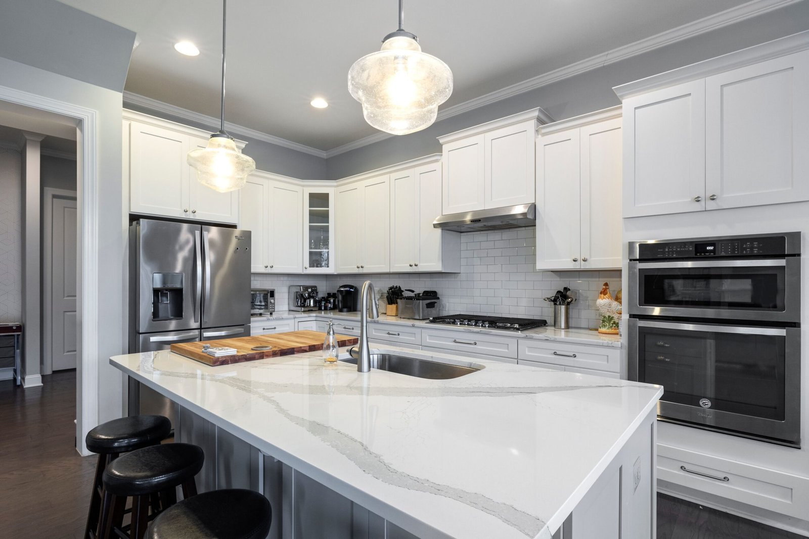 modern kitchen with marble countertop and stainless steel faucet over an undermount sink