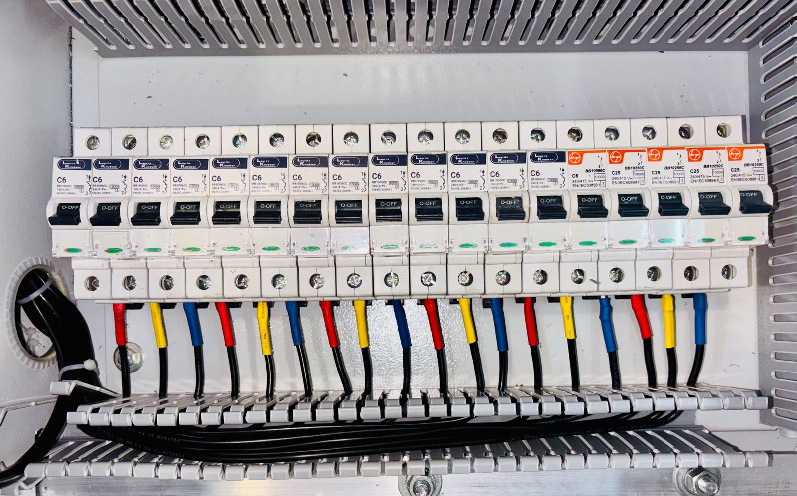 home electrical circuit breaker panel with color-coded wiring