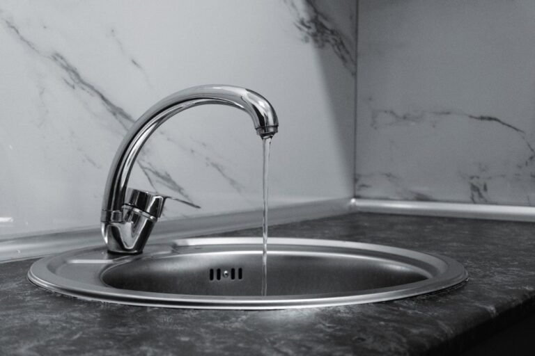 modern chrome kitchen faucet with water running, the kind of fixture a touch faucet upgrades