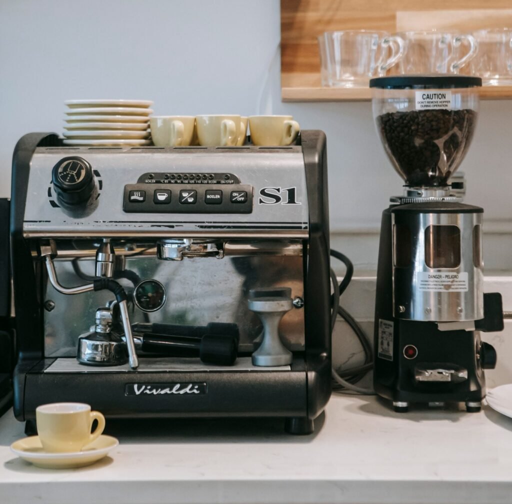 automatic drip coffee maker and grinder on a kitchen countertop
