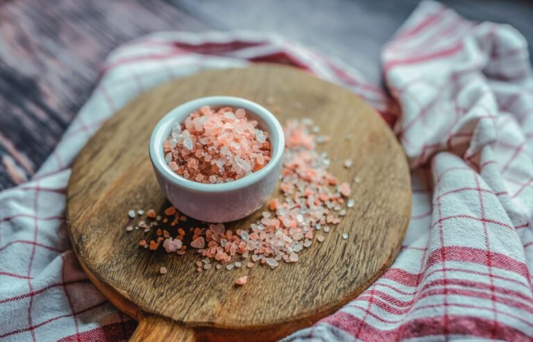 close up of pink Himalayan salt crystals in a small dish