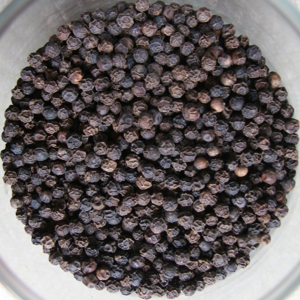 Close-up of whole black peppercorns