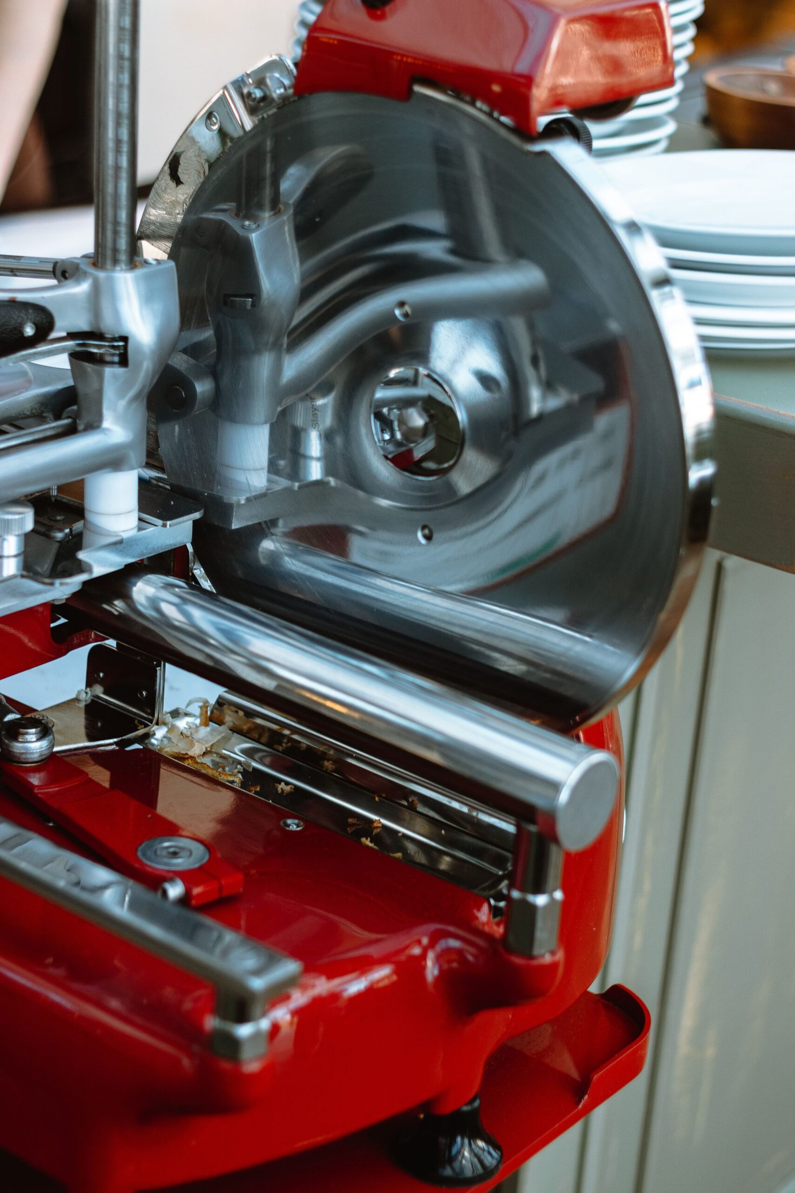 close-up of a stainless steel meat slicer blade and housing