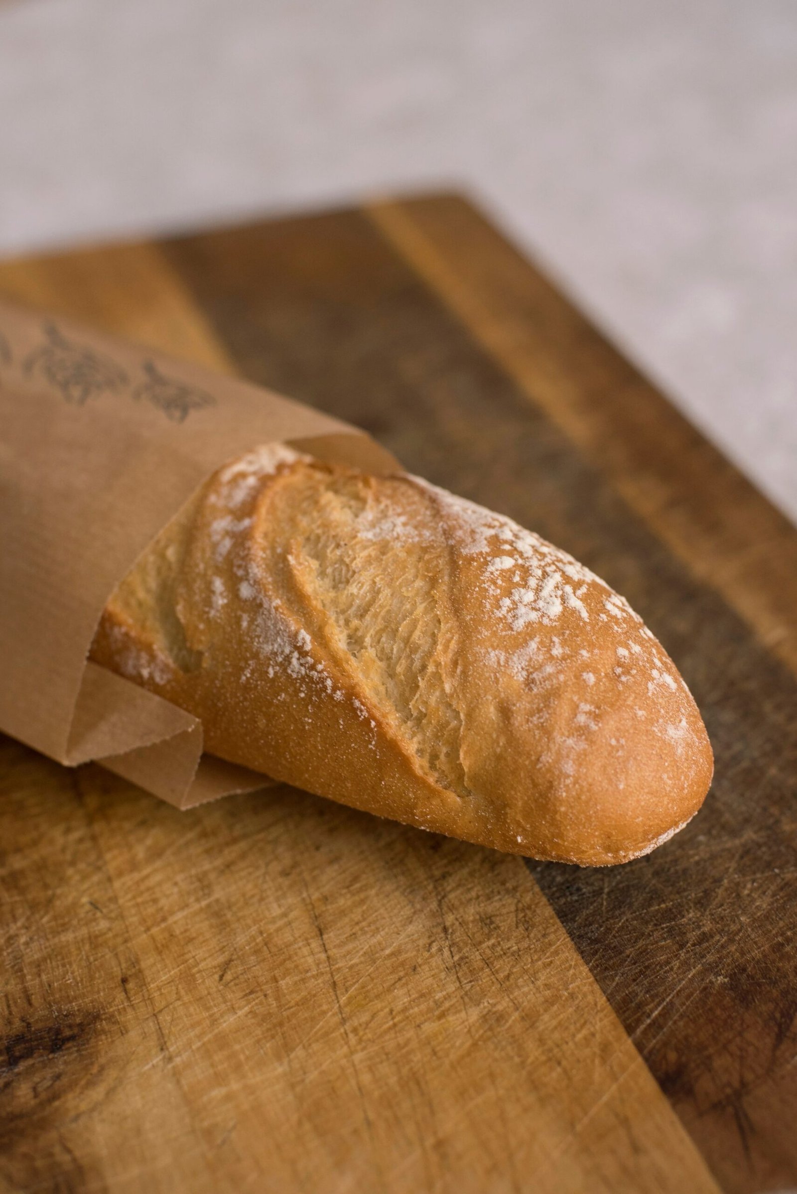 Loaf of bread wrapped in paper to keep it fresh and prevent mold