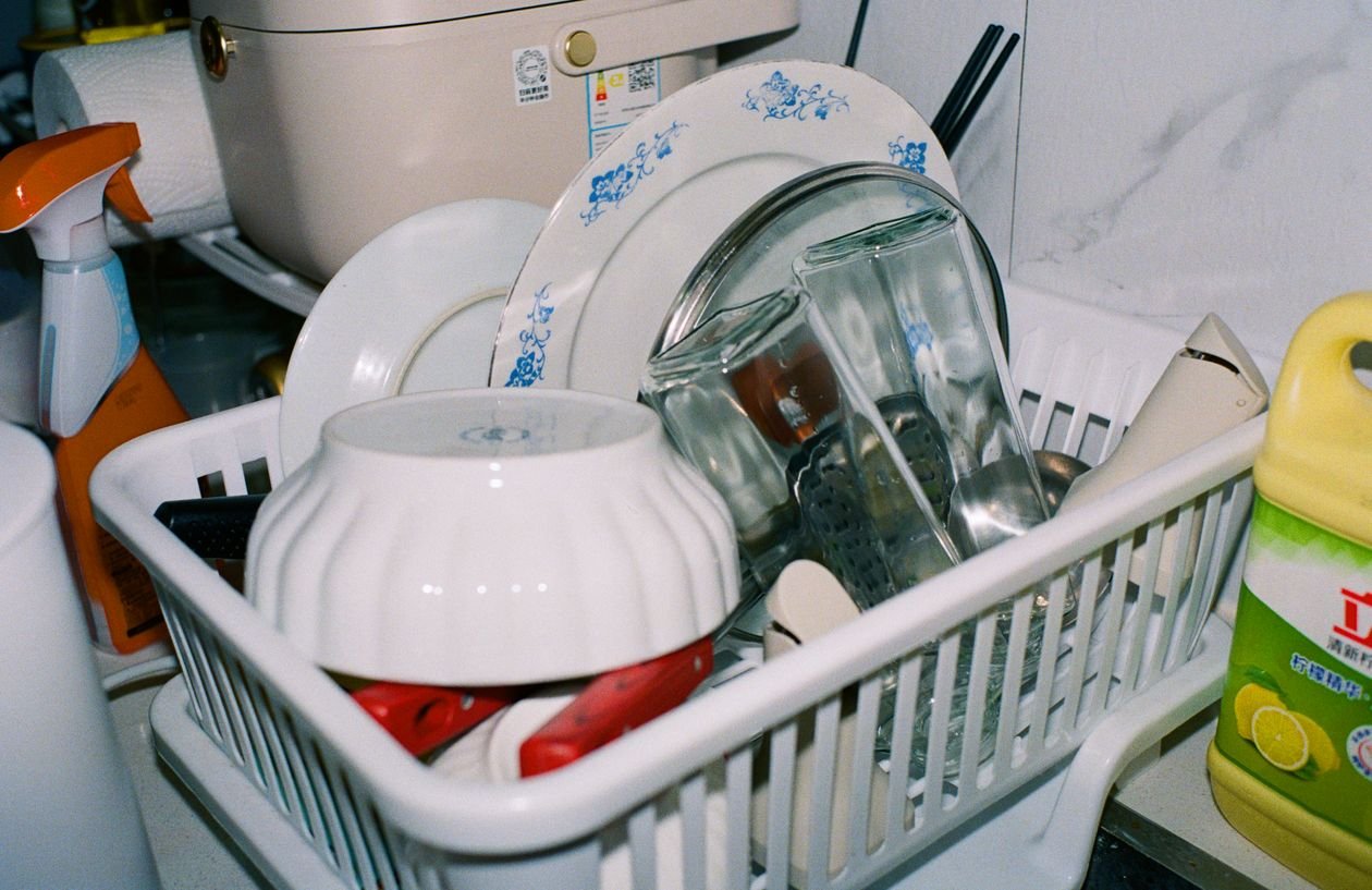 Clean plates and glasses drying in a dish rack