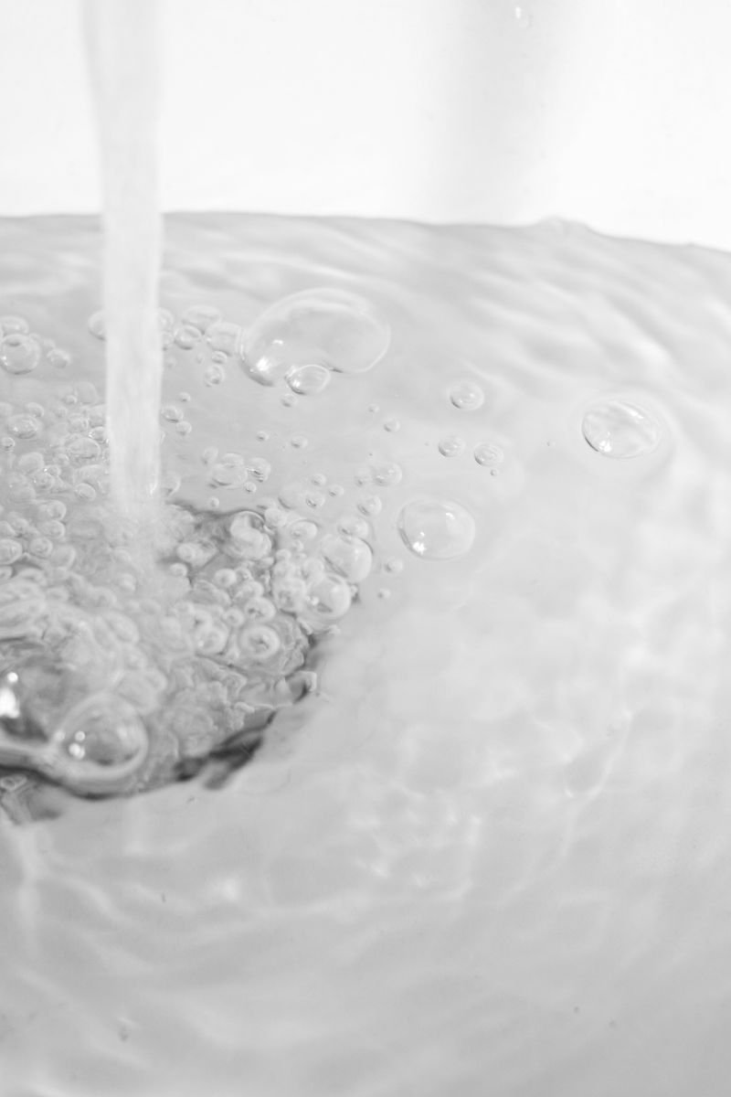 Cold water running into a kitchen sink before using the garbage disposal