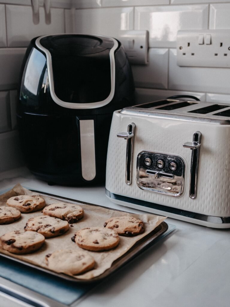 air fryer on a modern kitchen counter next to a toaster