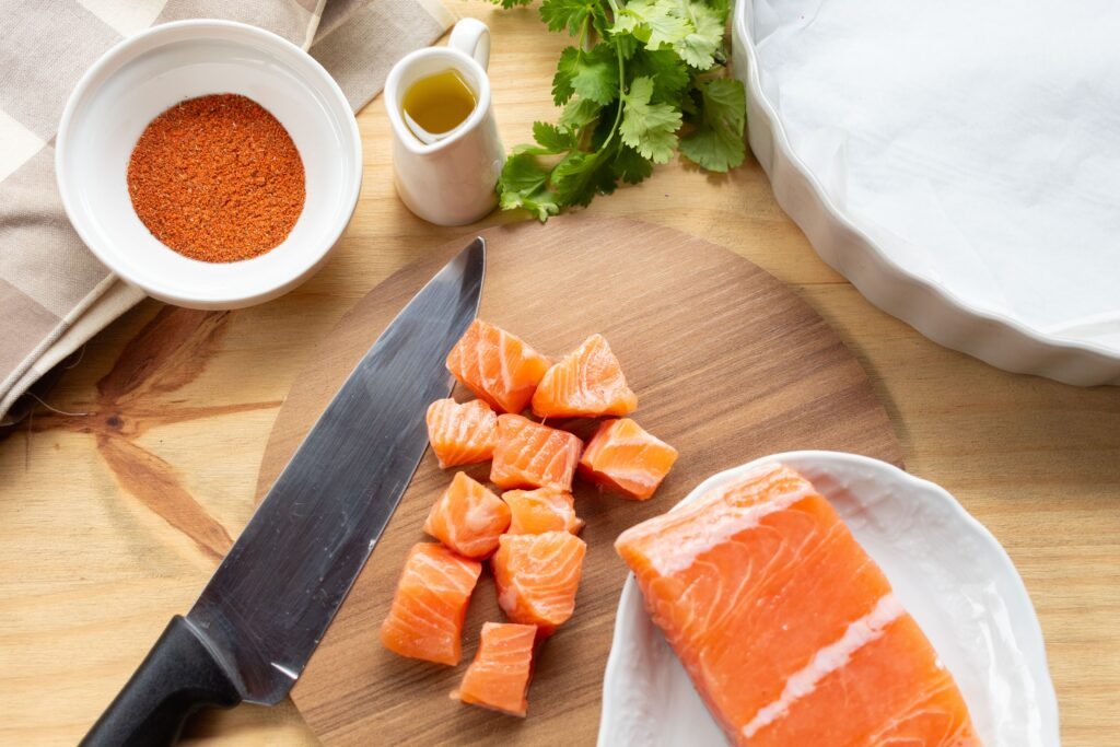 fresh salmon fillet seasoned on a wooden cutting board