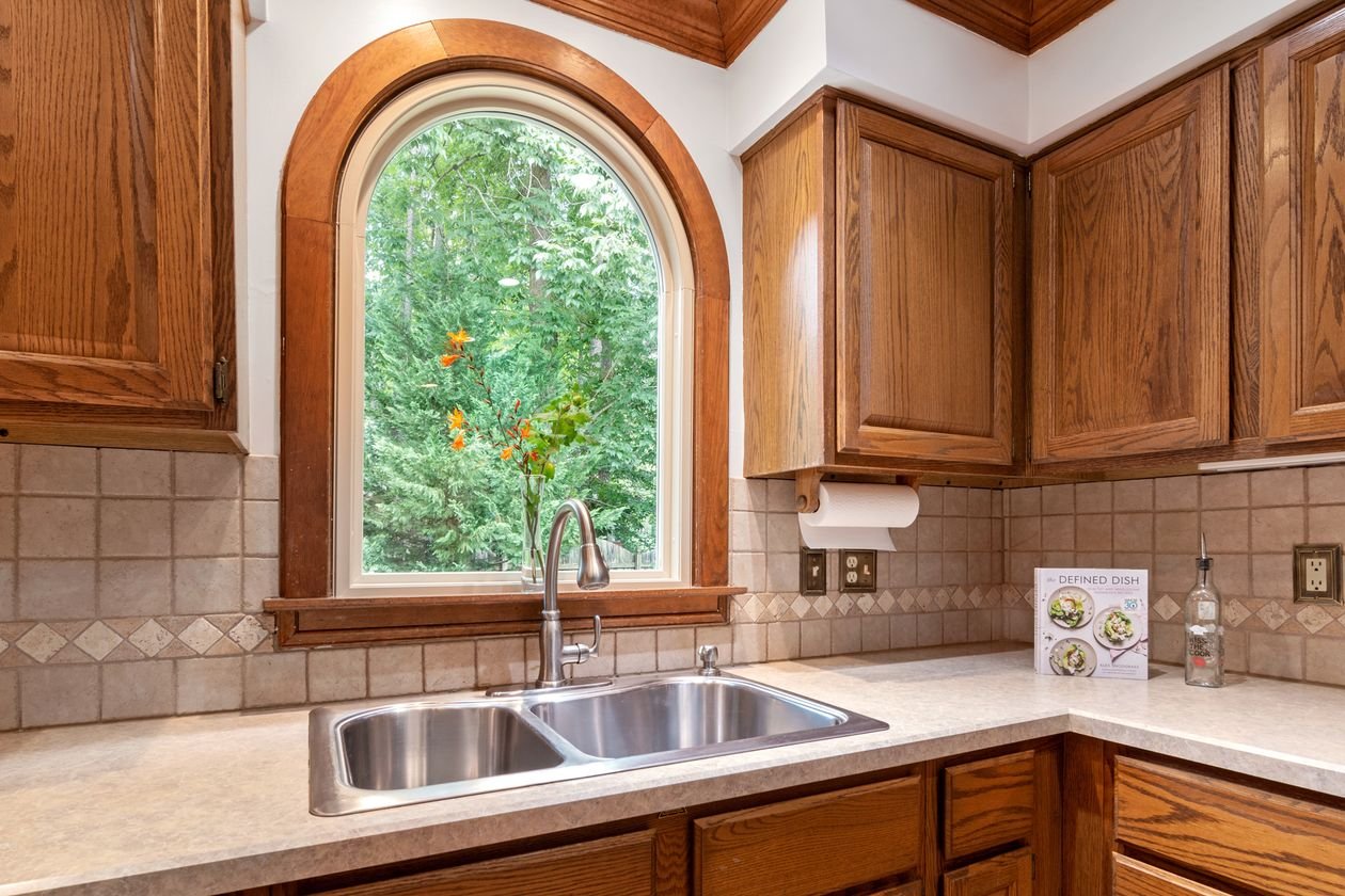 Traditional kitchen with a double sink under an arched window