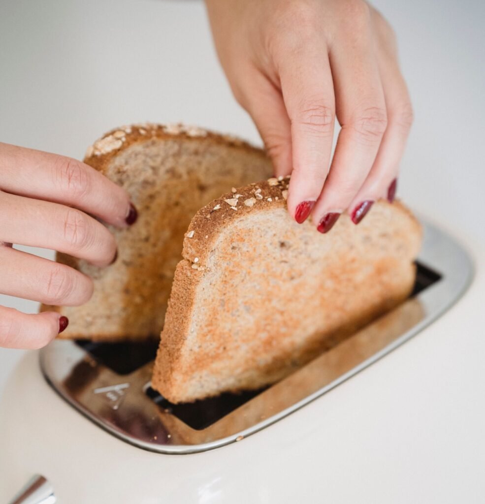 putting bread into a toaster to help keep sandwiches from getting soggy