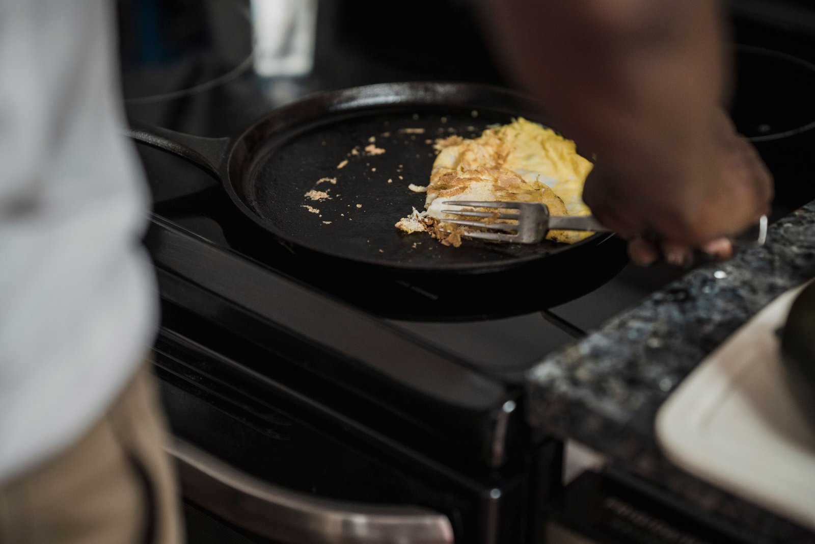 cooking eggs on a stovetop in a cast iron skillet cooking eggs on a stovetop in a cast iron skillet