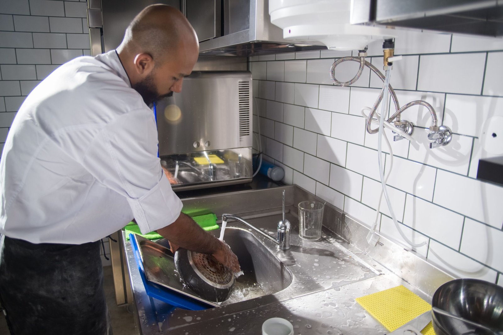 hand-washing a nonstick pan in the sink