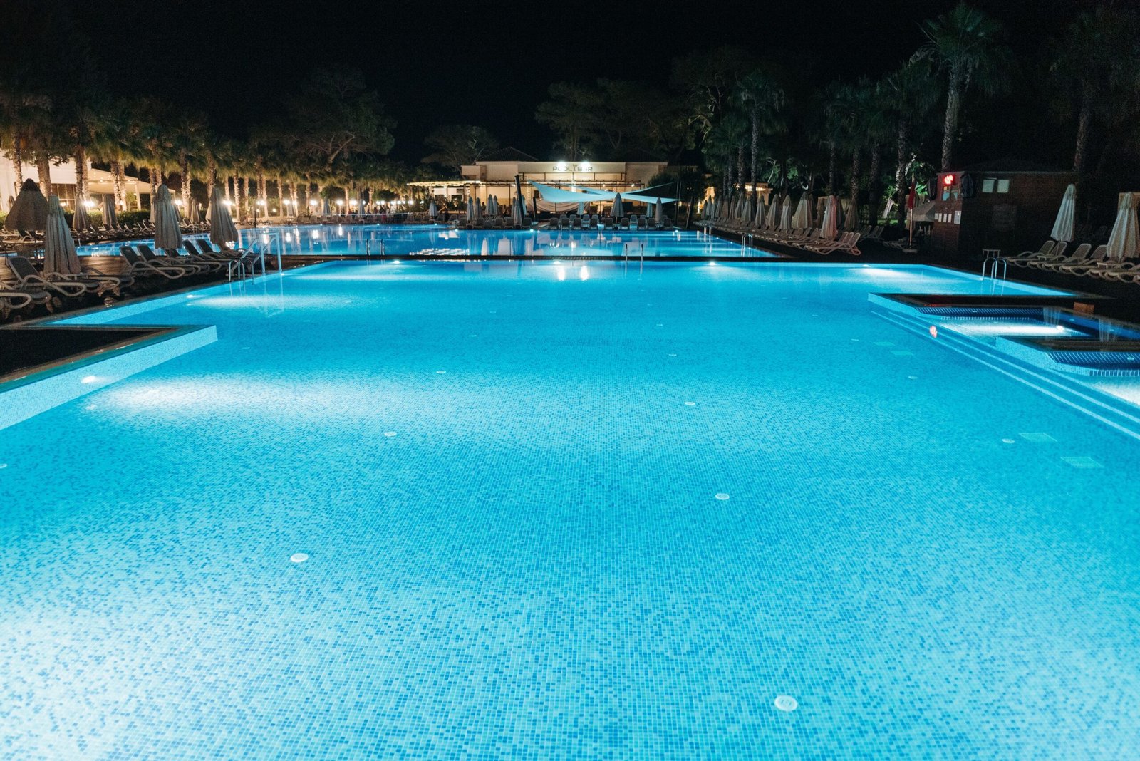 Illuminated swimming pool at night with ambient LED lighting