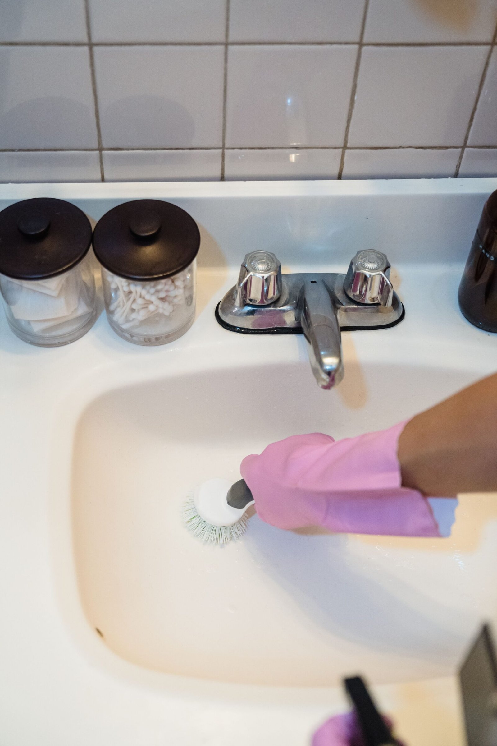 cleaning a bathroom sink affected by hard water
