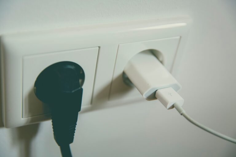 unplugging a small appliance from a wall outlet to save energy