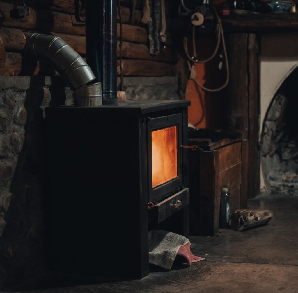 wood-burning stove with a visible flue pipe carrying exhaust gases outside